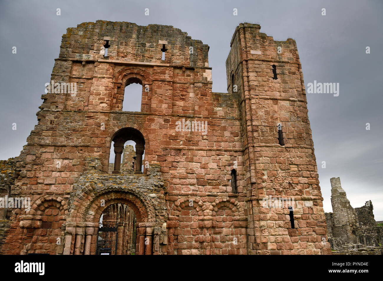 Front of Lindisfarne church and monastery ruins of the medieval priory with cross arrow loops on Holy Island of Lindisfarne England UK Stock Photo