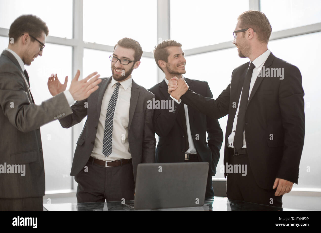 happy business colleagues giving each other a high five Stock Photo - Alamy