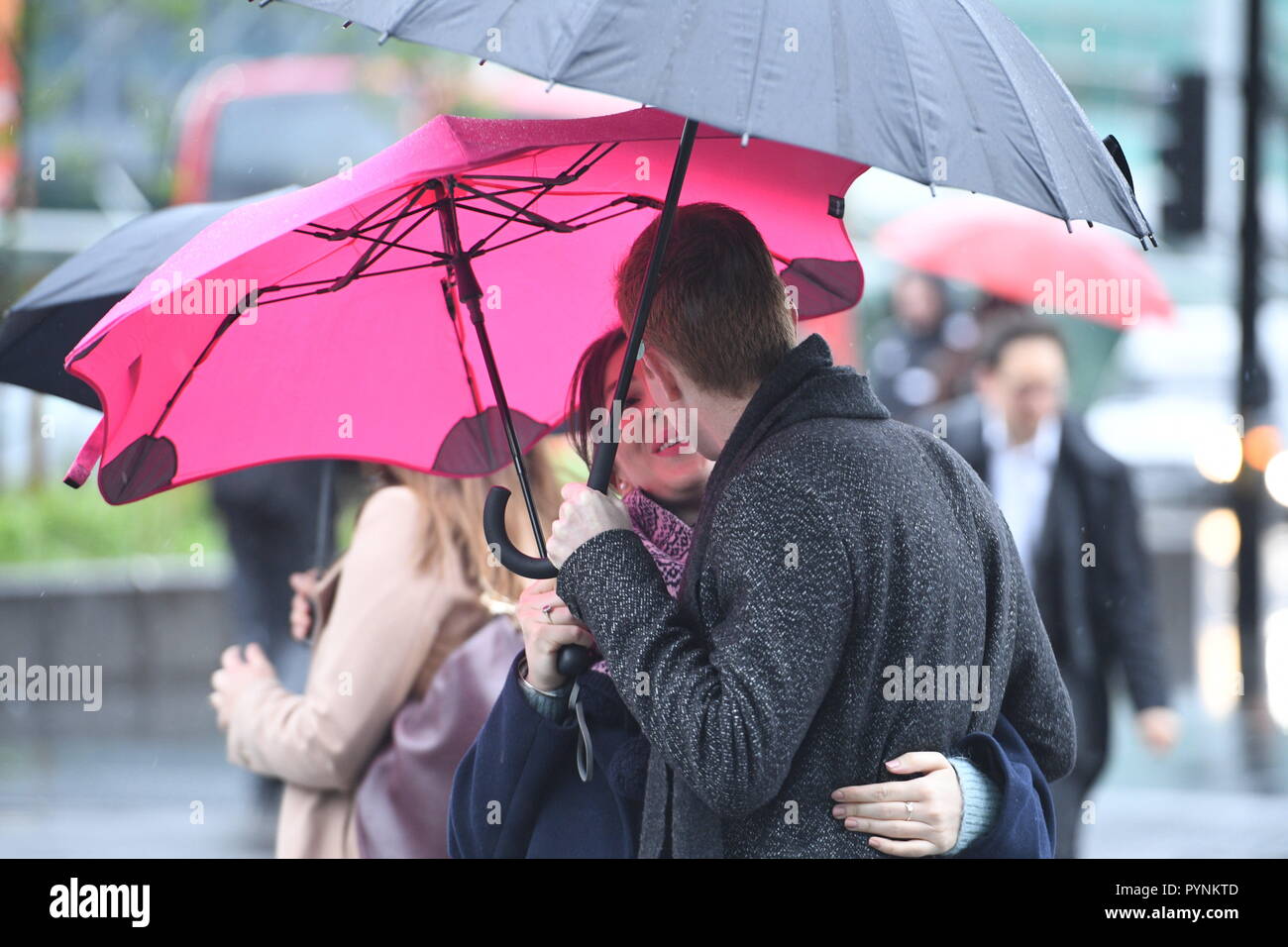 Rain and wind for commuters walking to work near Euston today. Picture Jeremy Selwyn Stock Photo