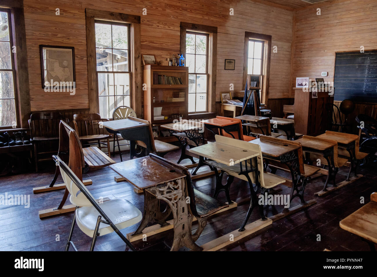 Vintage classroom in old one room schoolhouse with  rustic wooden desks and chairs. Wilmeth Schoolhouse, Chestnut Square, McKinney Texas. horizontal Stock Photo
