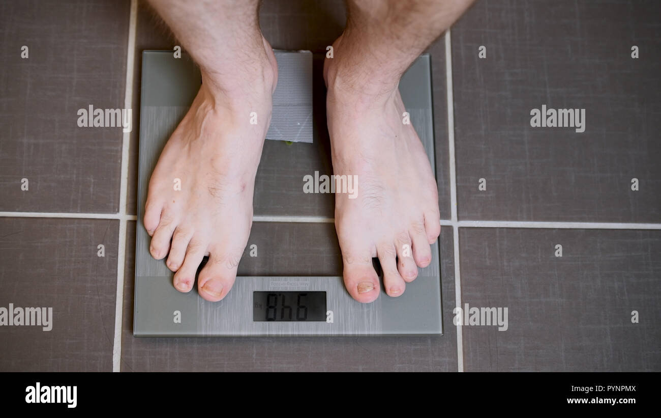 Male Feet On Glscales Menst Body Weight Close Up Man Standing On Scales Top Down View Male Feet On Glscales Menst Body Weight Close Up Man Standing On Scales Top Down View