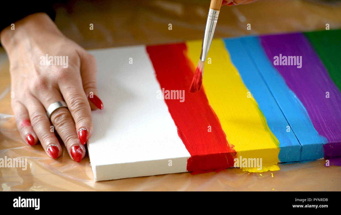 female artist painting a rainbow with acrylic colors on canvas hoe made art diy tutorial colorful PYNRDB