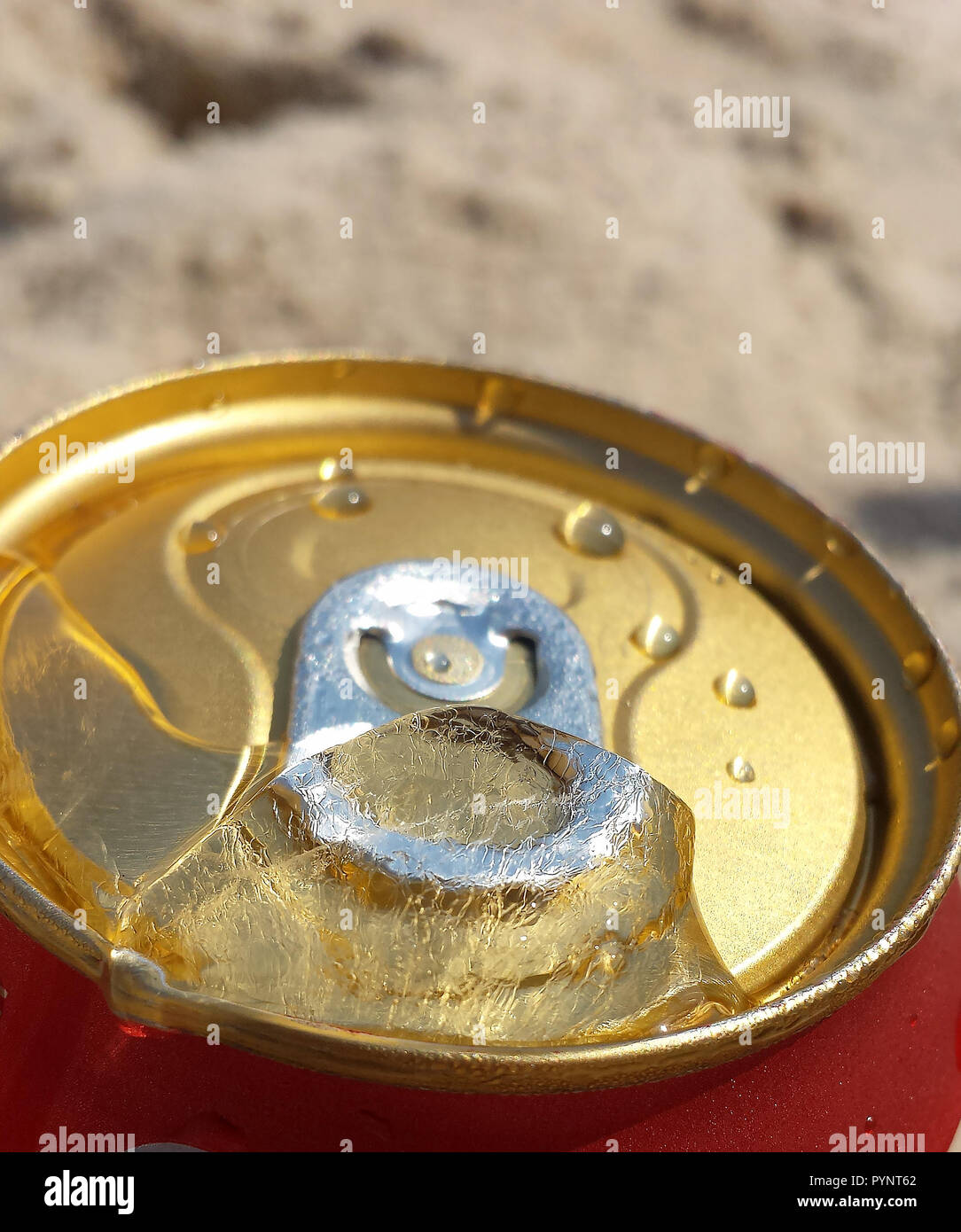 Can of beer very cold. Canned Beer with ice in the opening. Water drops