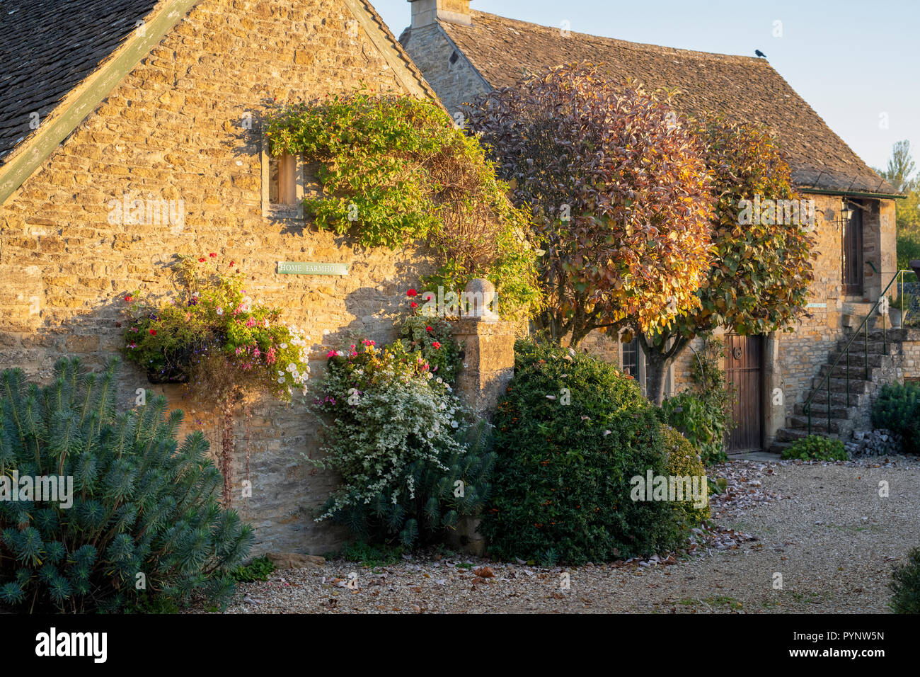 Home farmhouse cottages in the early morning autumn sunlight. Upper Slaughter. Cotswolds, Gloucestershire, England Stock Photo