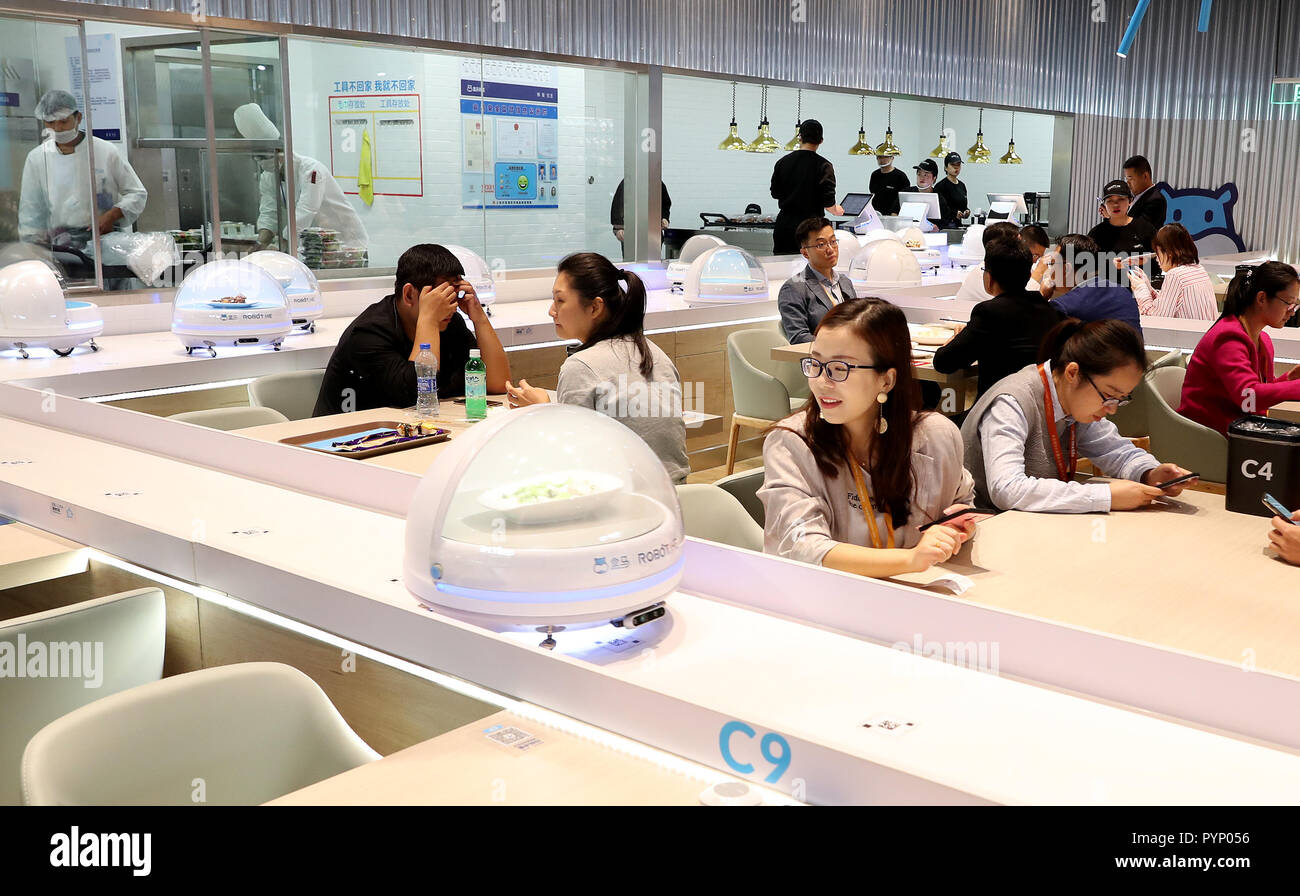 Shanghai, China. 15th Oct, 2018. People enjoy food at a Robot.He restaurant  at the National Exhibition and Convention Center (Shanghai), the main venue  to hold the upcoming first China International Import Expo (