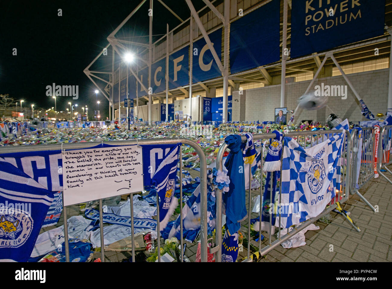 Leicester, UK. 29th Oct, 2018. Flowers and tributes illuminated at the King Power Leicester City Football ground after the owner Vichai Srivaddhanaprabha was killed in his helicopter on Saturday. Credit: robin palmer/Alamy Live News Stock Photo