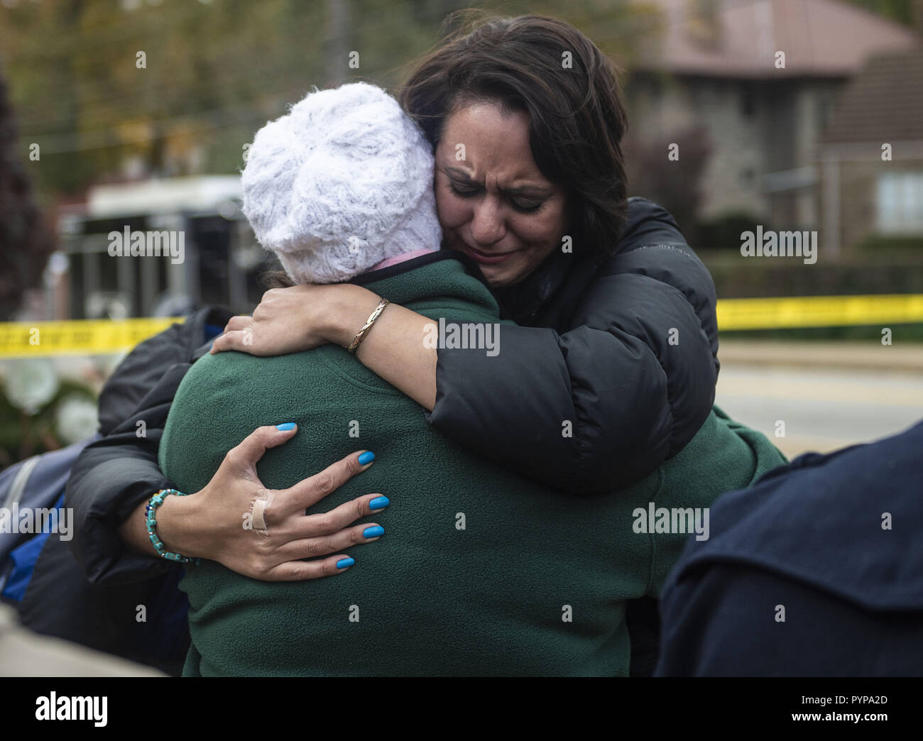 Pittsburgh, Pennsylvania, USA. 29th Oct, 2018. Community members comfort each other during an impromptu memorial service for the victims of the Tree of Life Massacre. Members of Pittsburgh and the Squirrel Hill community pay their respects at the memorial to the 11 victims of the Tree of Life Synagogue massacre perpetrated by suspect Robert Bowers on Saturday, October 27. Credit: Matthew Hatcher/SOPA Images/ZUMA Wire/Alamy Live News Stock Photo