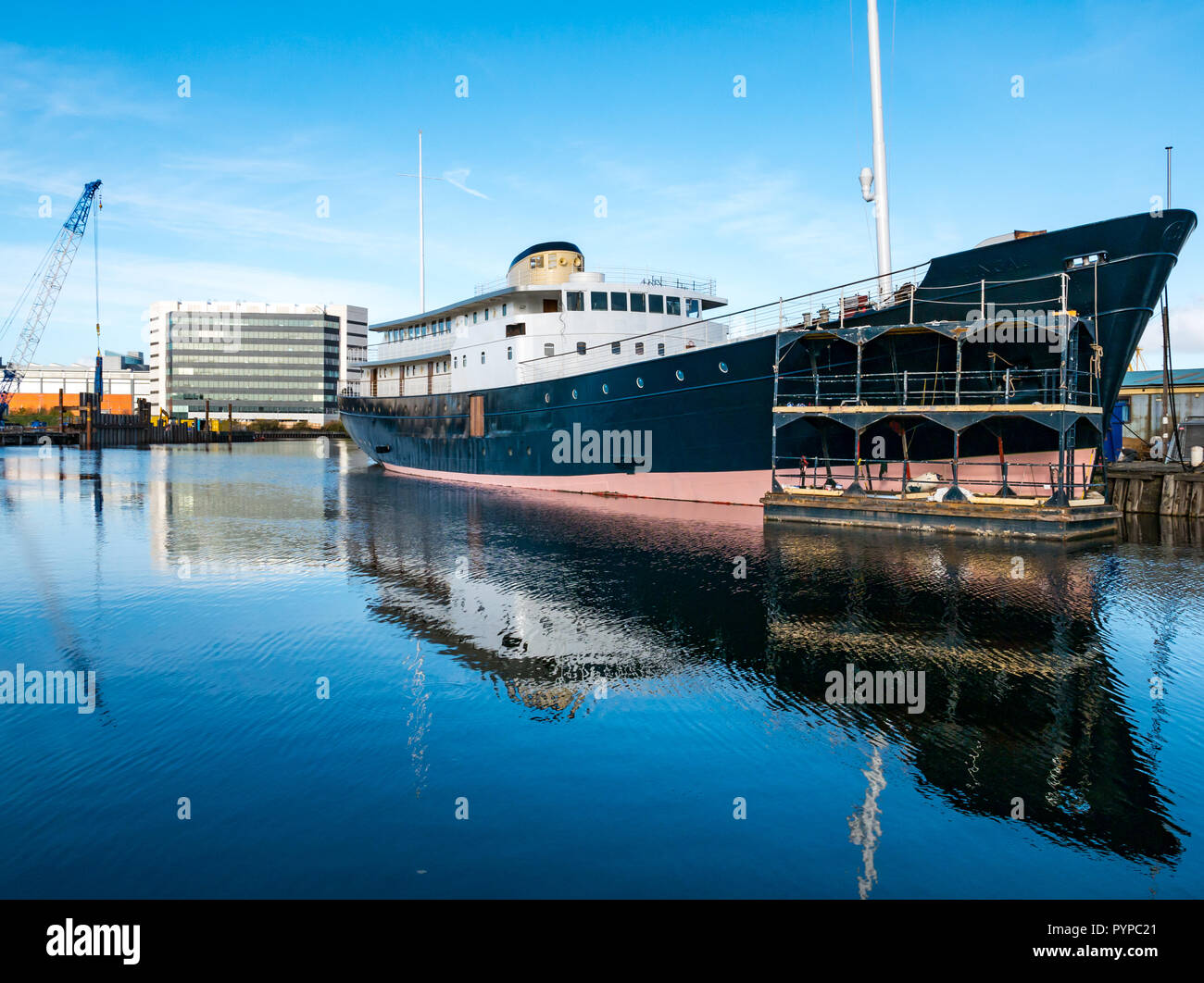 Leith docks, Edinburgh, Scotland, United Kingdom. 30th Oct, 2018. UK Weather: Sunshine on Leith this morning creates colourful reflections in the Water of Leith river. MV Fingal ship continues its refit and repainting in the dock from a former lighthouse tender to a luxury floating hotel due to open in January 2019 Stock Photo