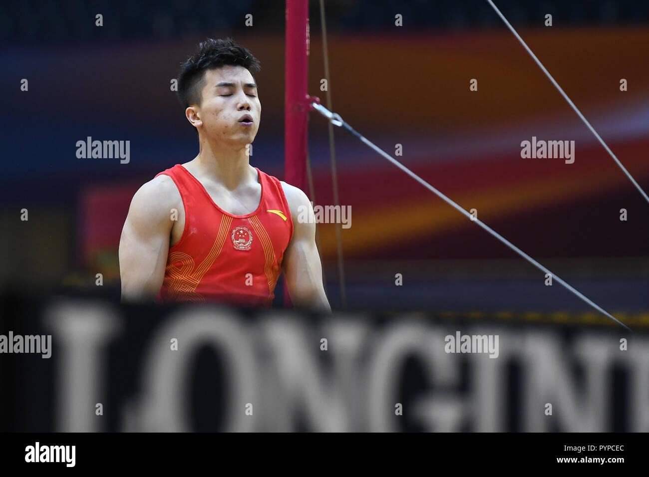Doha, Qatar. 29th Oct, 2018. LIN CHAOPAN from China breathes a sign of relief after he dismounts the high bar during the Team Finals competition held at the Aspire Dome in Doha, Qatar. Credit: Amy Sanderson/ZUMA Wire/Alamy Live News Stock Photo