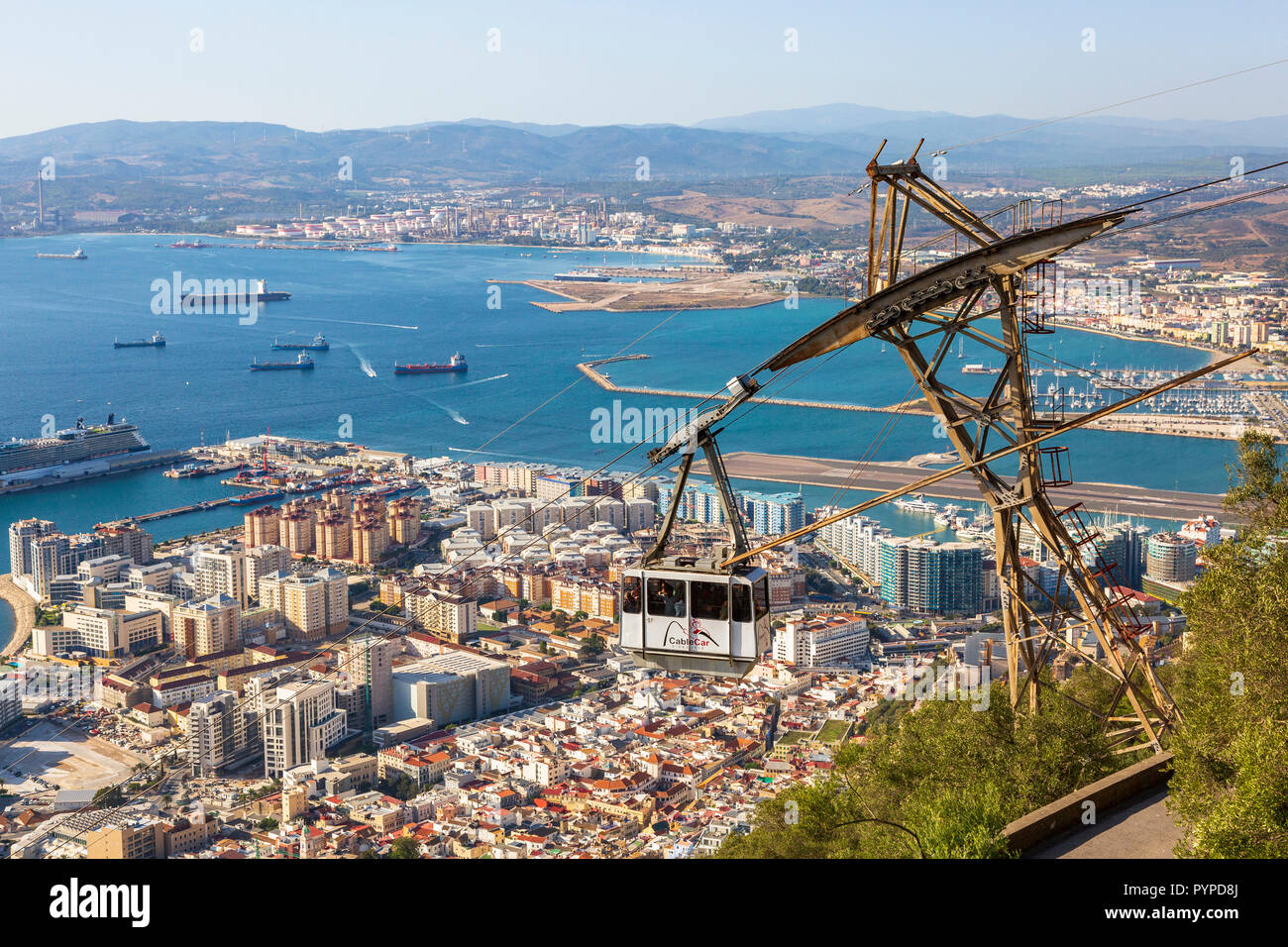 View over the Bay of Gibraltar from the Rock of Gibraltar showing the tourist styled cable car travelling from Gibraltar town to the top of the Rock Stock Photo