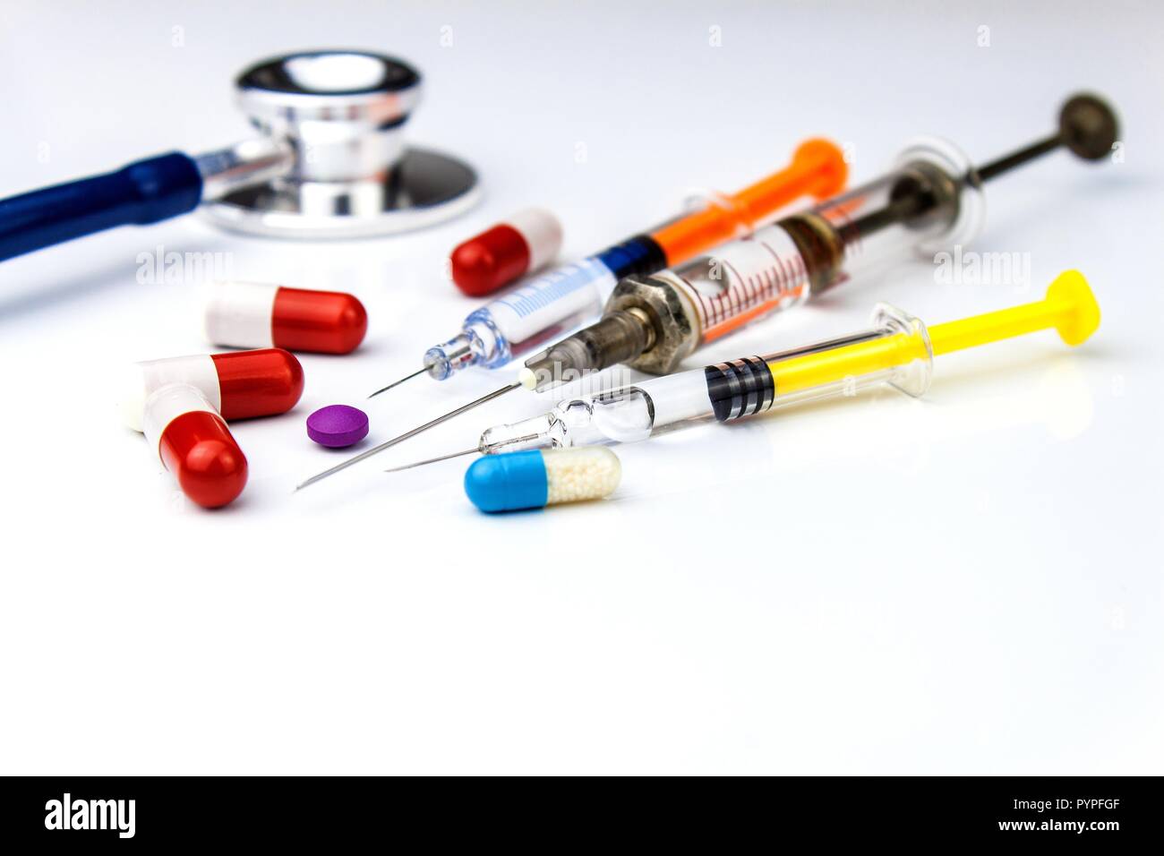 Assorted medical drugs and syringe on white background. Injection for