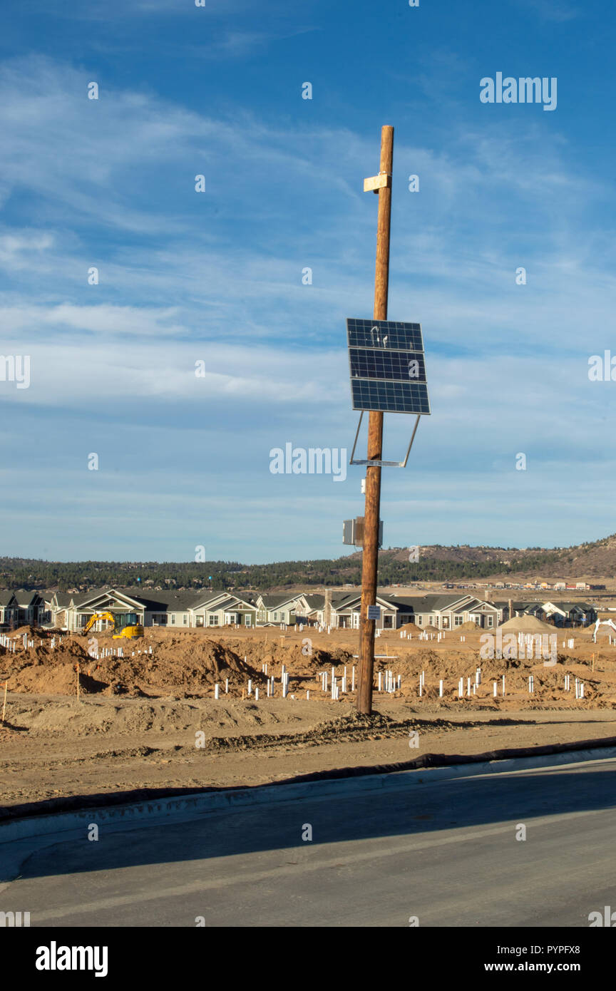 Solar panel on a pole used to power a security camera Stock Photo