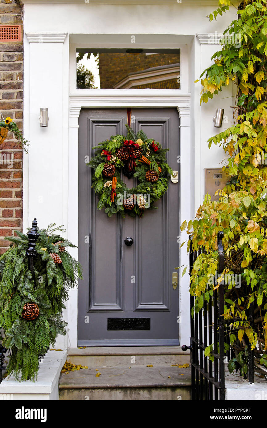Door with natural wreath decoration for Christmas holiday Stock Photo