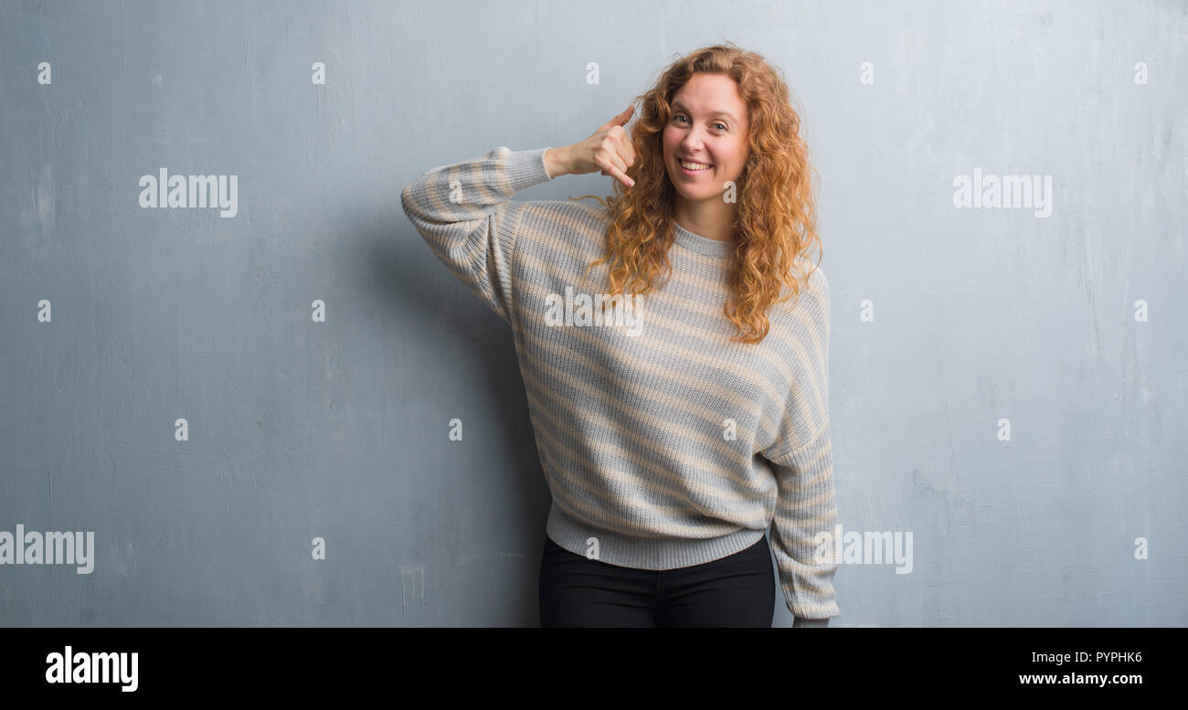 Young Redhead Woman Over Grey Grunge Wall Smiling Doing