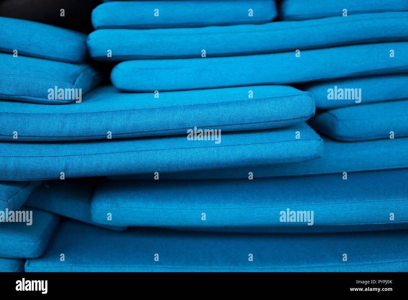 The mountain of blue pillows lie on one another. Pillow texture. Stock Photo