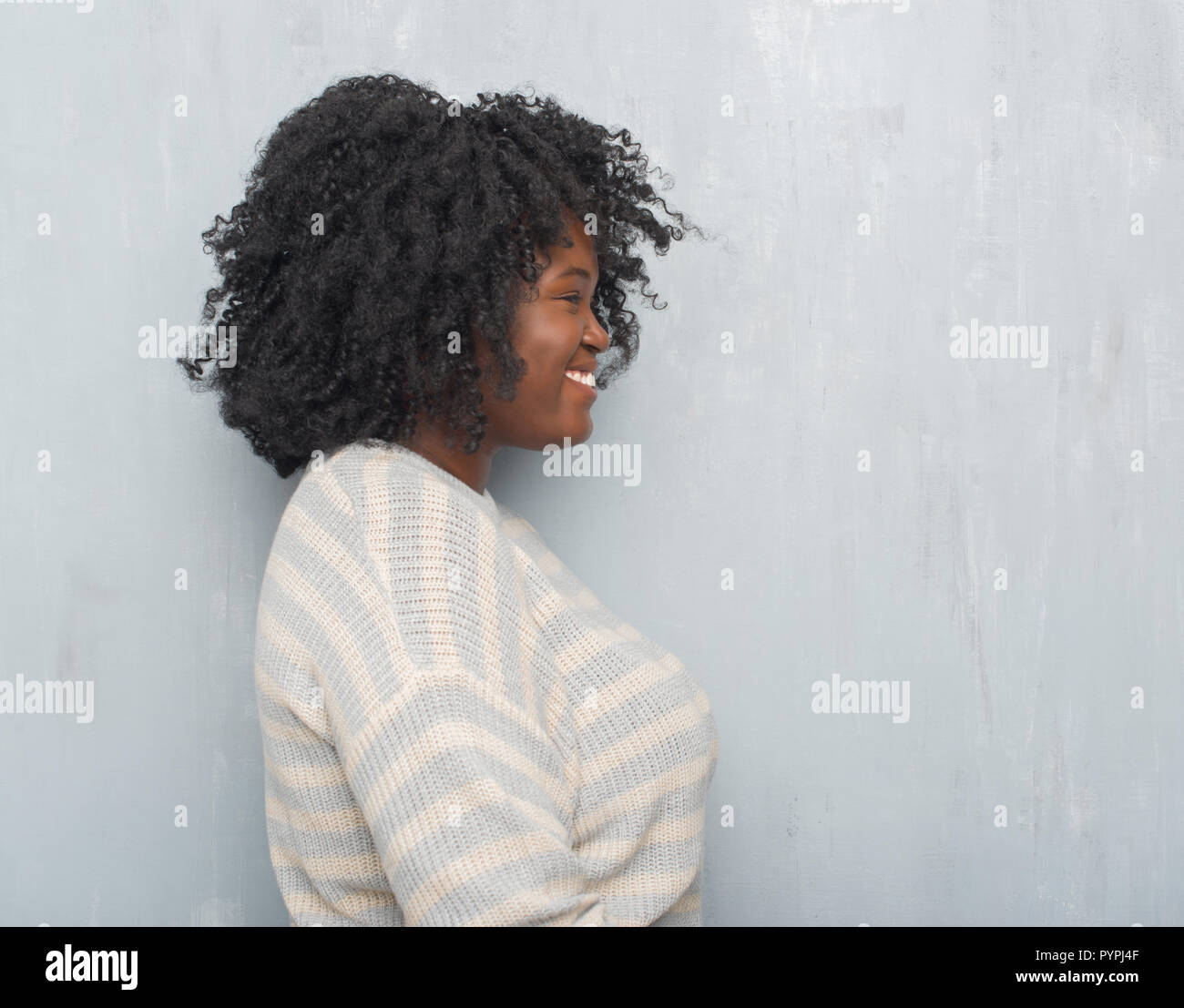 Young African American Plus Size Woman Over Grey Grunge Wall
