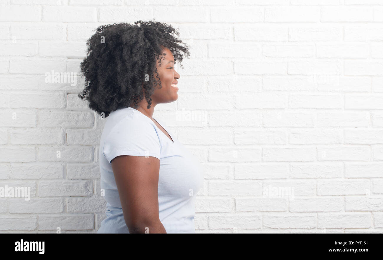 Young African American Plus Size Woman Over White Brick Wall