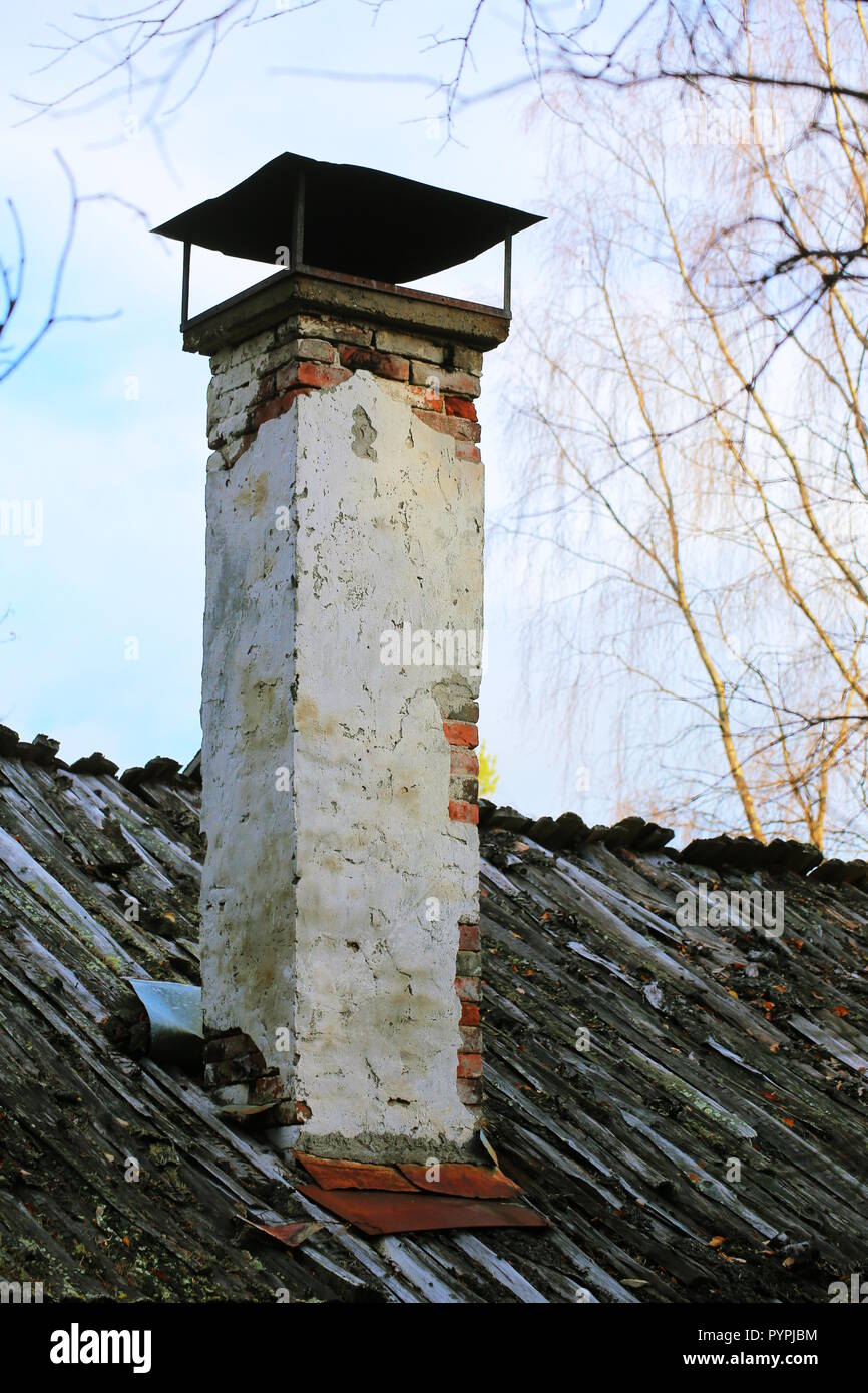 Old Chimney on a wooden lath roof. Stock Photo
