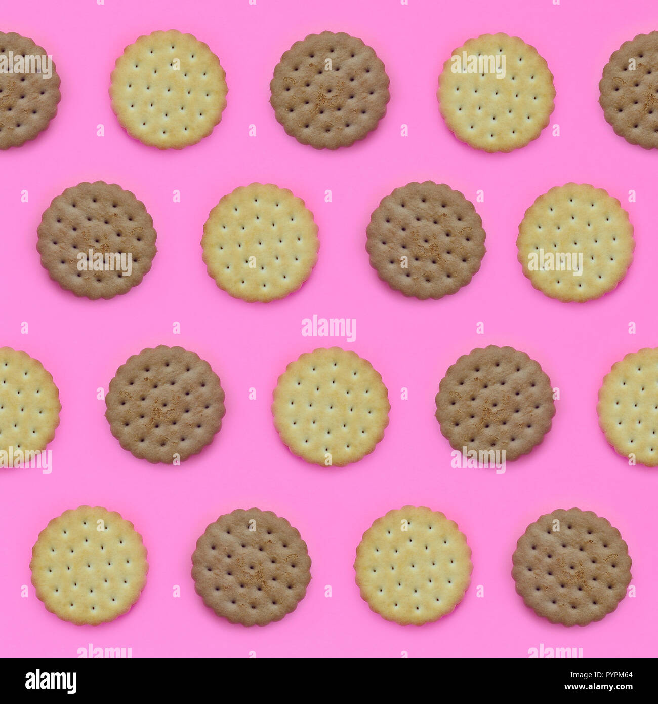 Pattern of a brown biscuits on a pink background. Trendy minimal ...