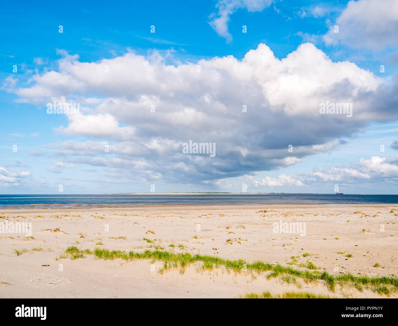 View from Boschplaat on Terschelling island to tidal outlet Borndiep and Ameland island with lighthouse, Wadden Sea, Netherlands Stock Photo