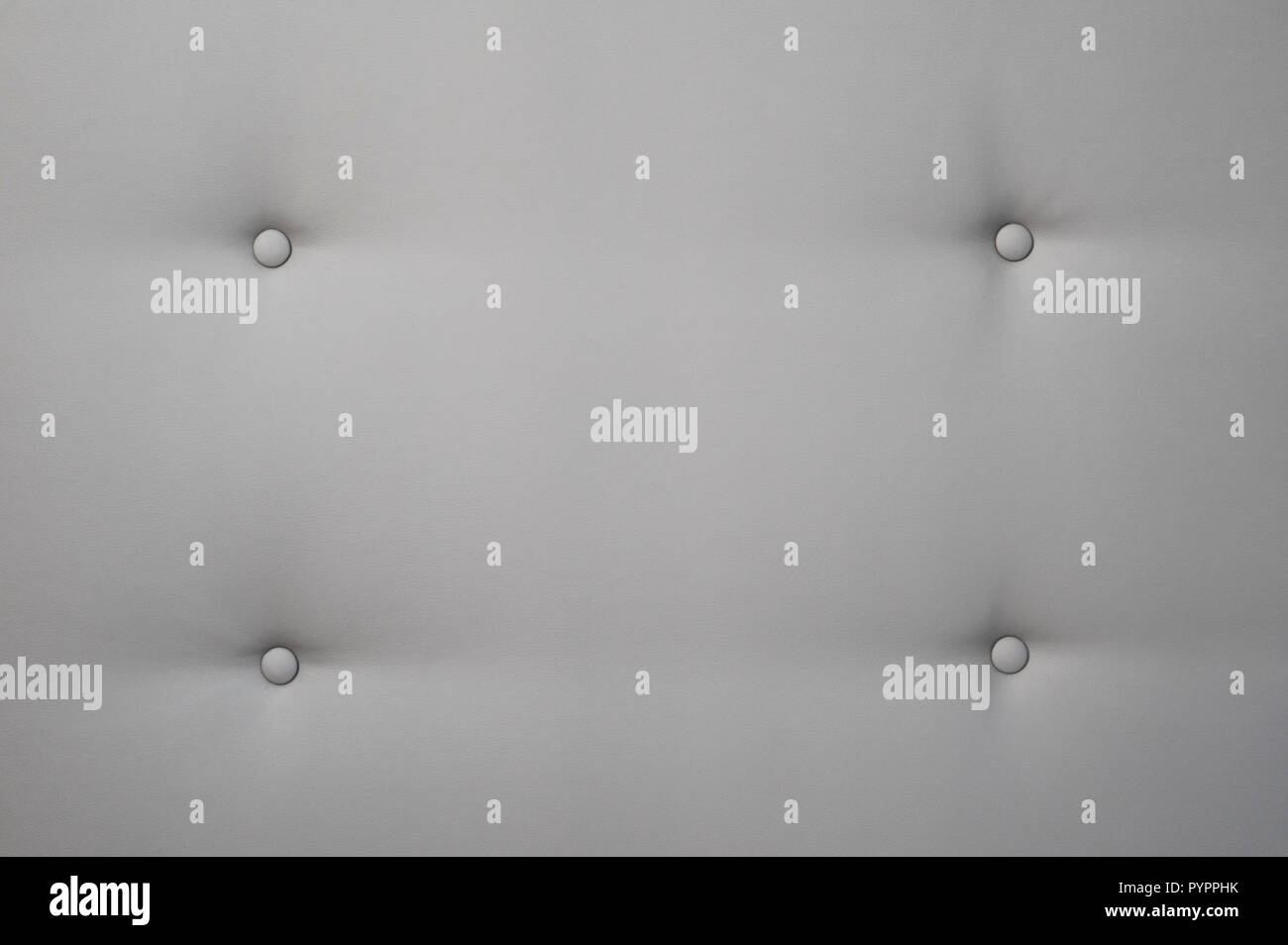Creamy leather sofa background with buttons as a texture. Stock Photo