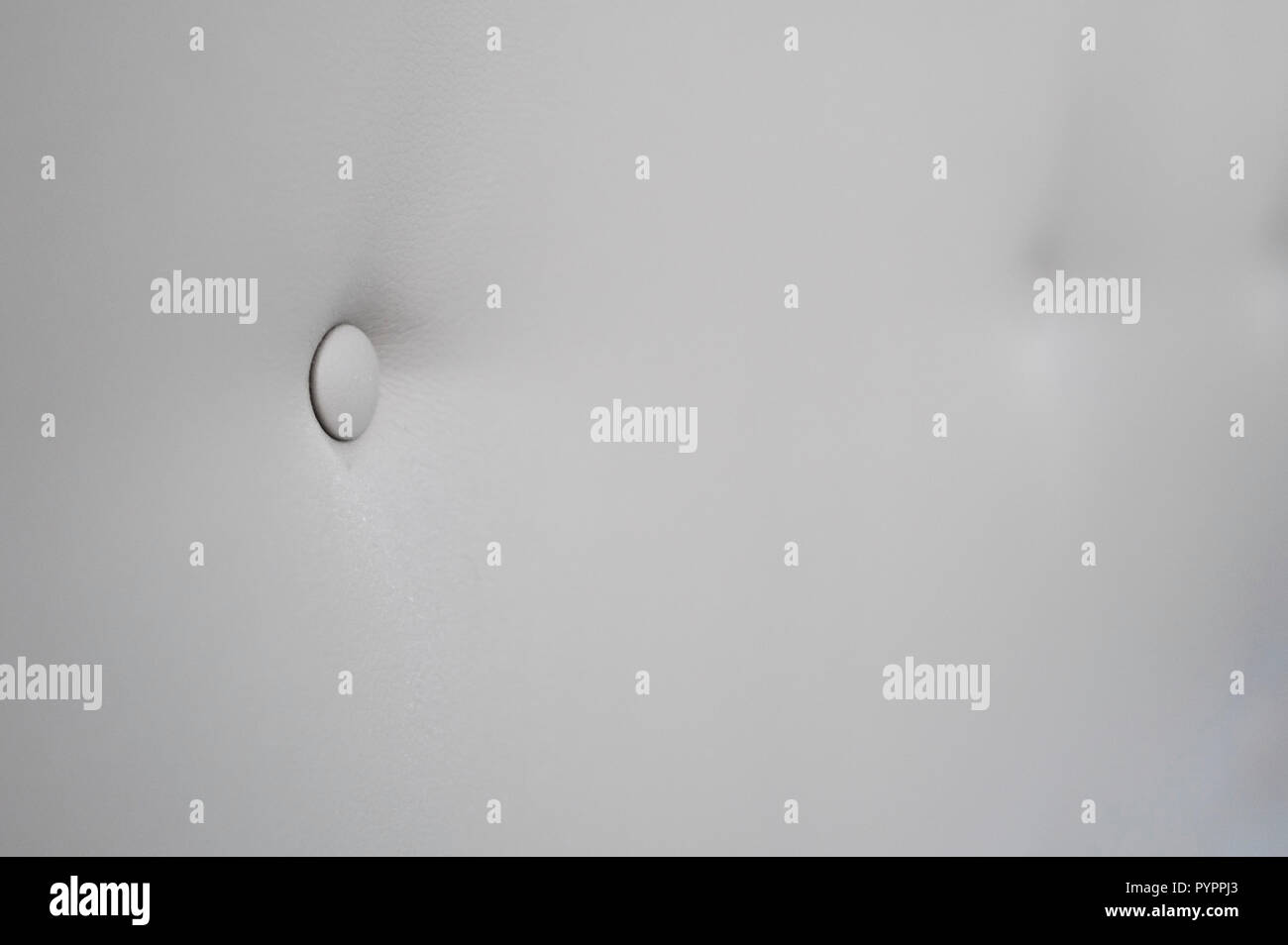 Creamy leather sofa background with buttons as a texture. Stock Photo