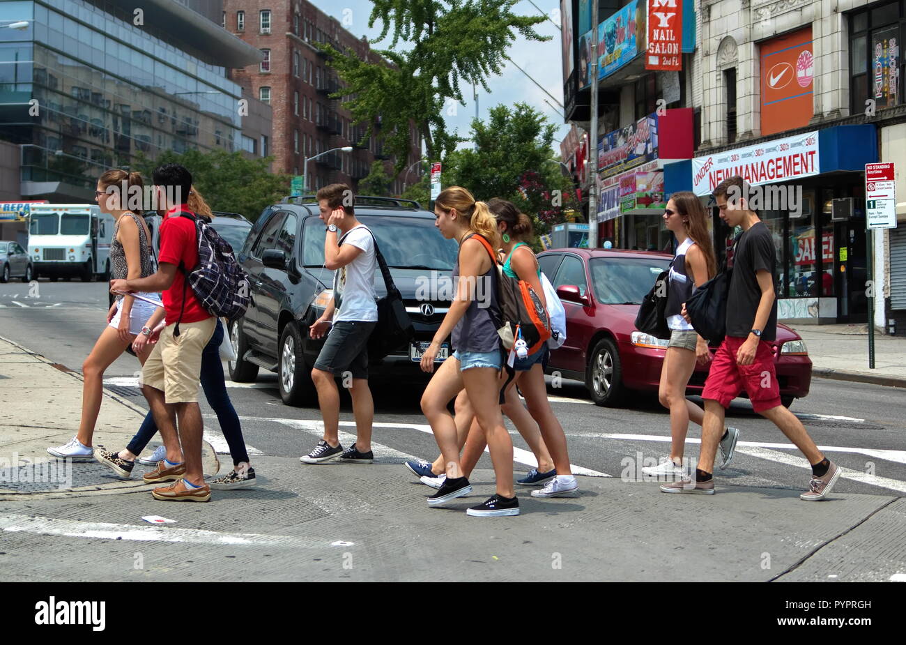 New York City, NY USA. Jul 2014. Teenagers on a busy New York city crosswalk on the way to school. Stock Photo
