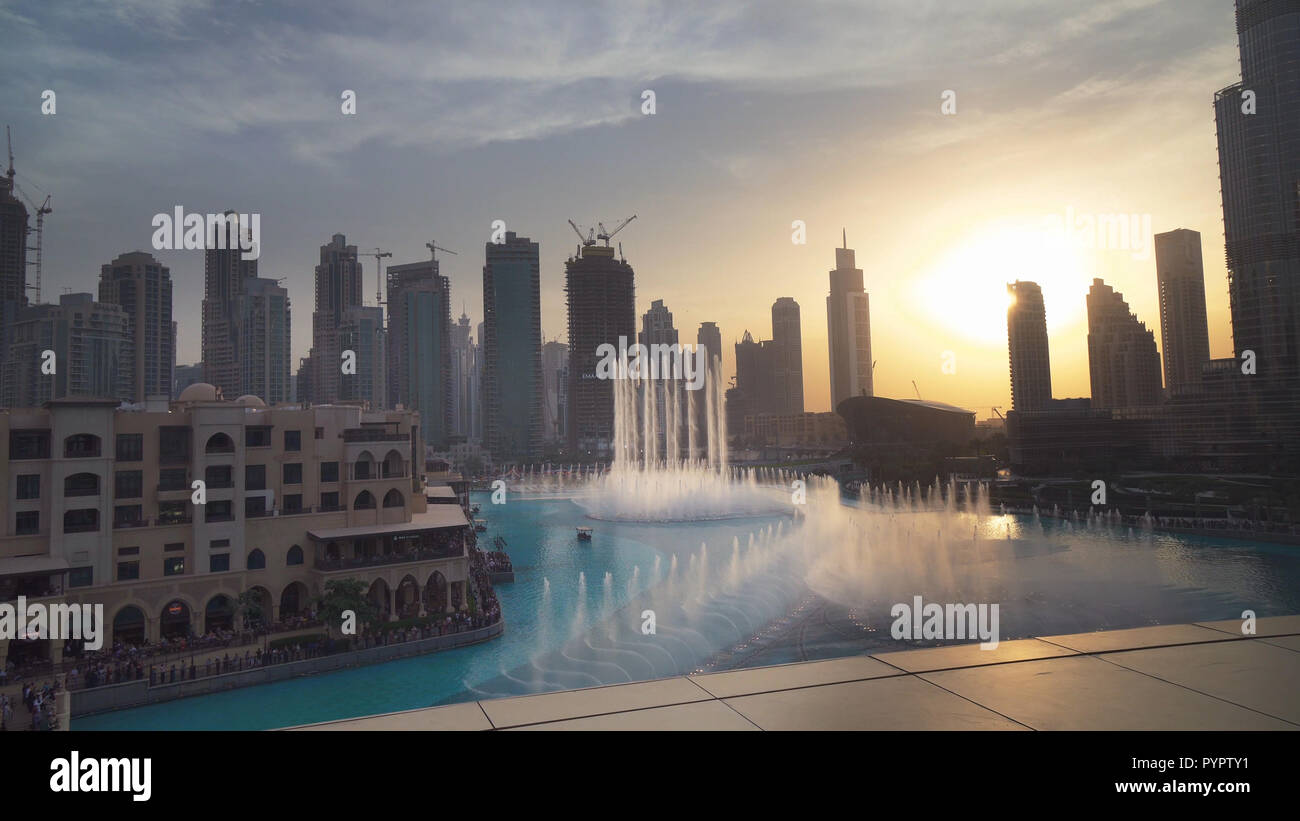 Dubai Fountain is the world's largest choreographed fountain system on sunset background Stock Photo