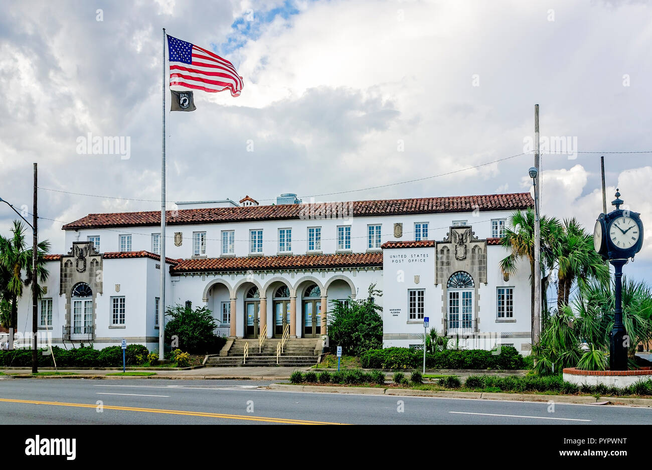 An American flag flies with a POW/MIA flag in front of the historic Marianna post office, Oct. 20, 2018, in Marianna, Florida. Stock Photo