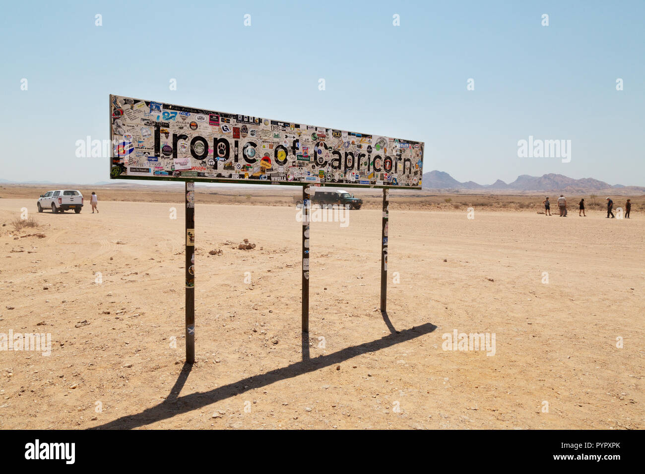 Tropic of Capricorn  Namibia - Tourists at the Tropic of Capricorn sign in the Namib Desert, Namibia Africa Stock Photo