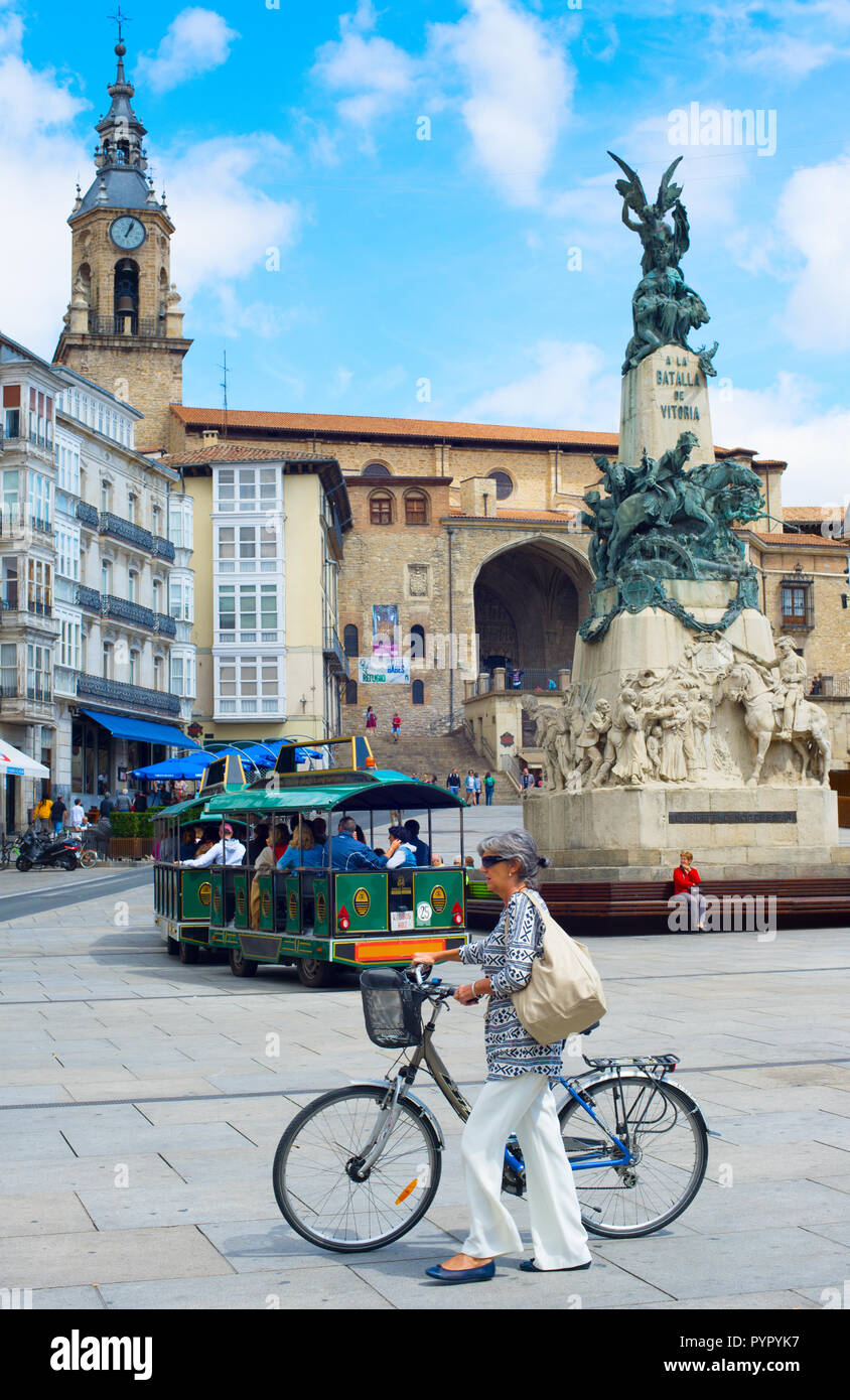 Senior elegant woman with bicycle on Plaza Espagna central square of Vitoria-Gasteiz, Spain Stock Photo