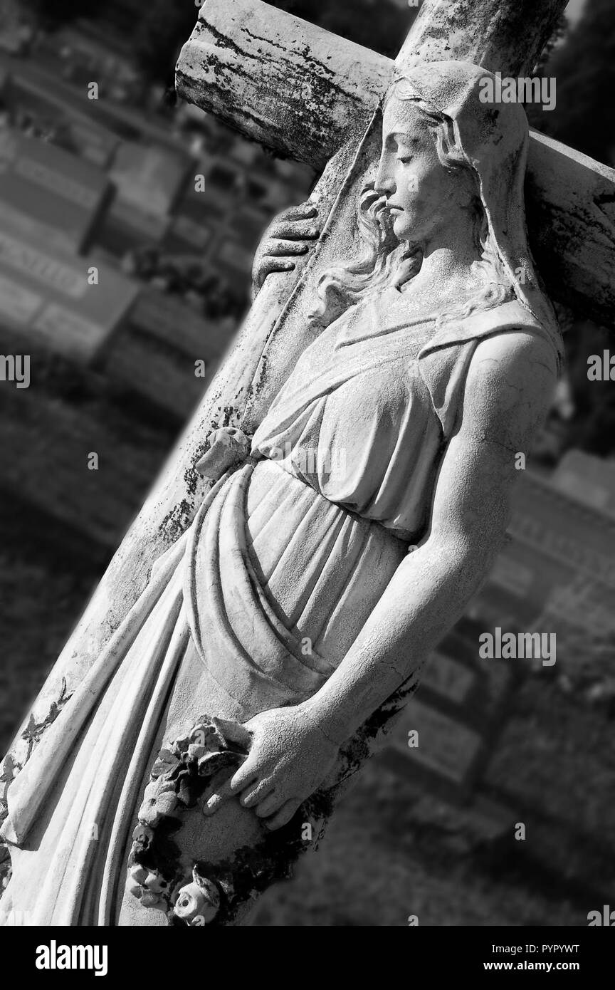 Woman at a Cross in St. Bernard's Cemetery in Black and White Stock Photo