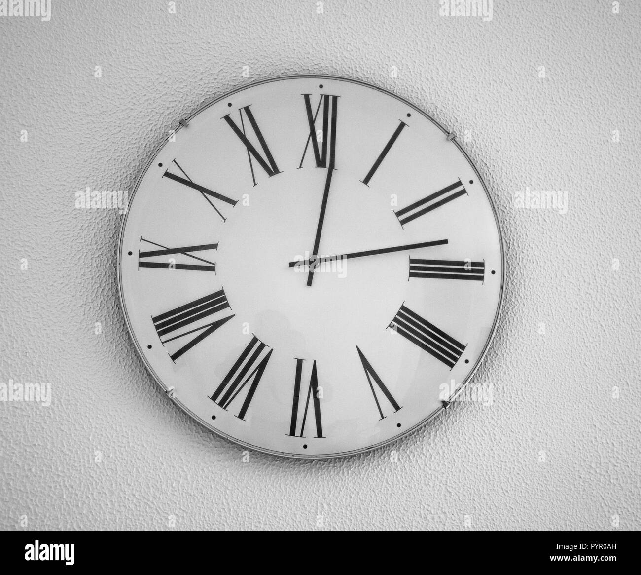 Wall clock with the Roman figures Stock Photo Alamy