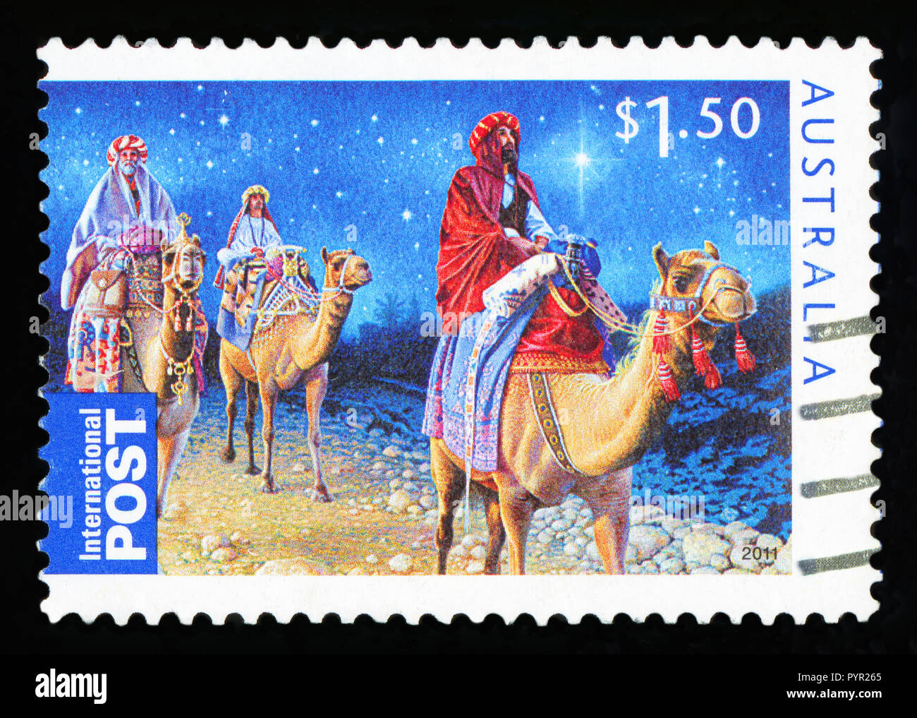 AUSTRALIA - CIRCA 2011: An Australian Used Christmas Postage Stamp showing the Three Kings riding on Camels, circa 2011 Stock Photo