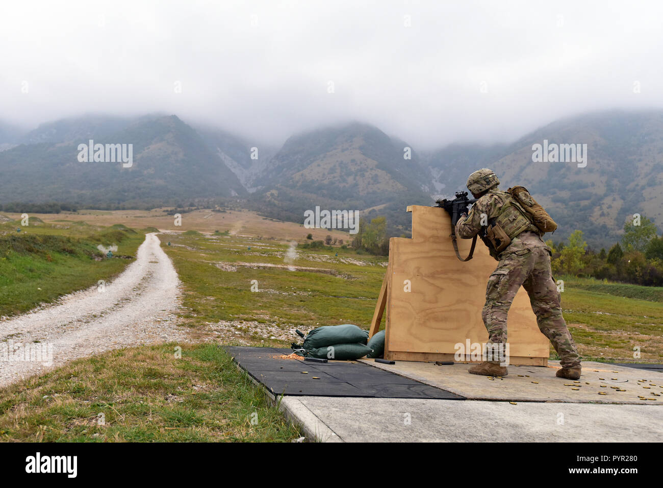 U.S. Army Paratrooper assigned to the 1st Battalion, 503rd Infantry Regiment, 173rd Airborne Brigade engages a pop-up targets with M4 carbine during the marksmanship training at Cao Malnisio Range, Pordenone, Italy, Oct. 25, 2018. The 173rd Airborne Brigade is the U.S. Army Contingency Response Force in Europe, capable of projecting ready forces anywhere in the U.S. European, Africa or Central Commands' areas of responsibility. (U.S. Army Photos by Paolo Bovo) Stock Photo