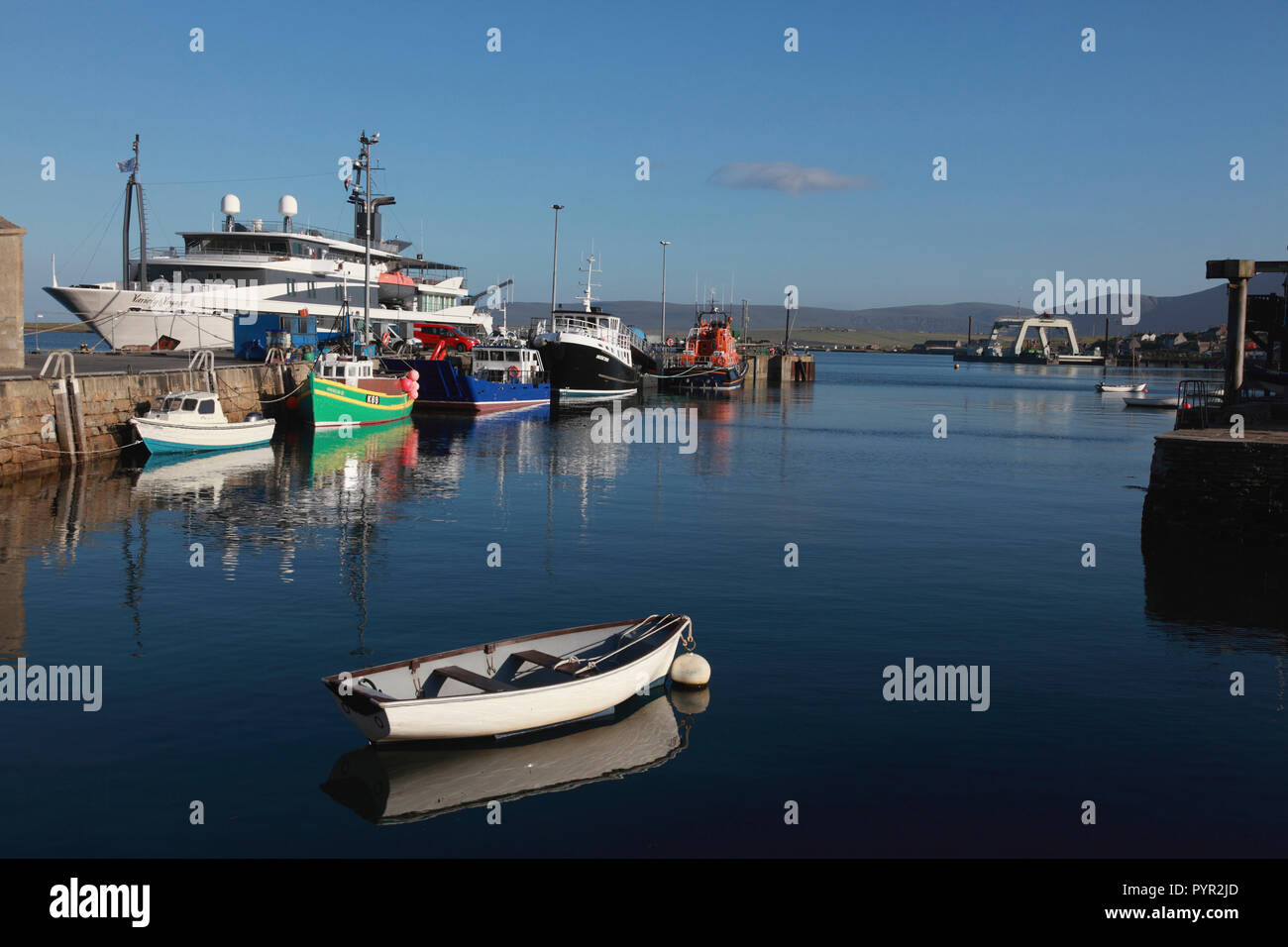 The harbour in Stromness, Orkney with fishing boats, the lifeboat and the passenger cruise ship, Variety Voyager Stock Photo