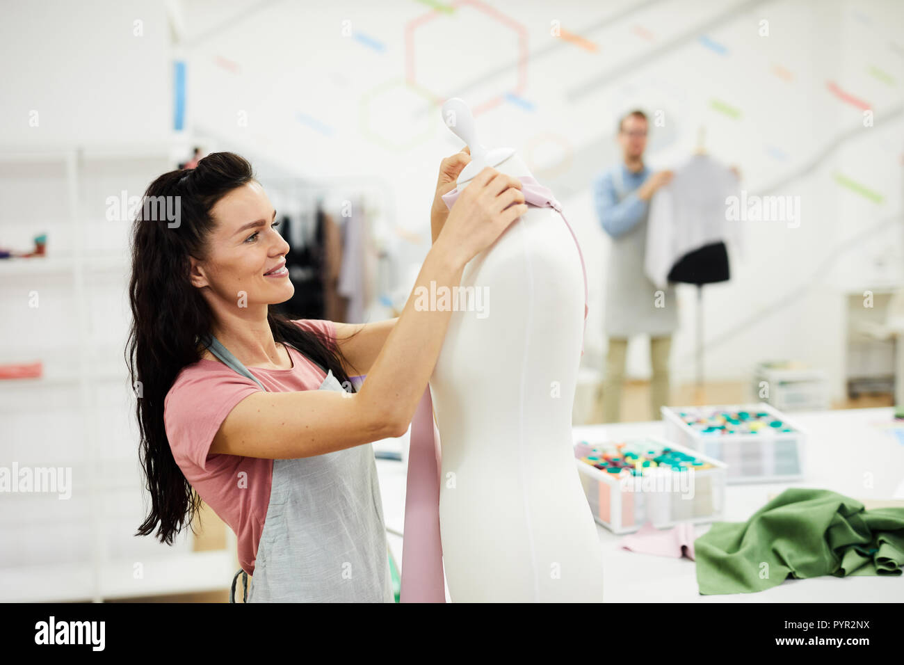 Happy female tailor enjoying her work Stock Photo