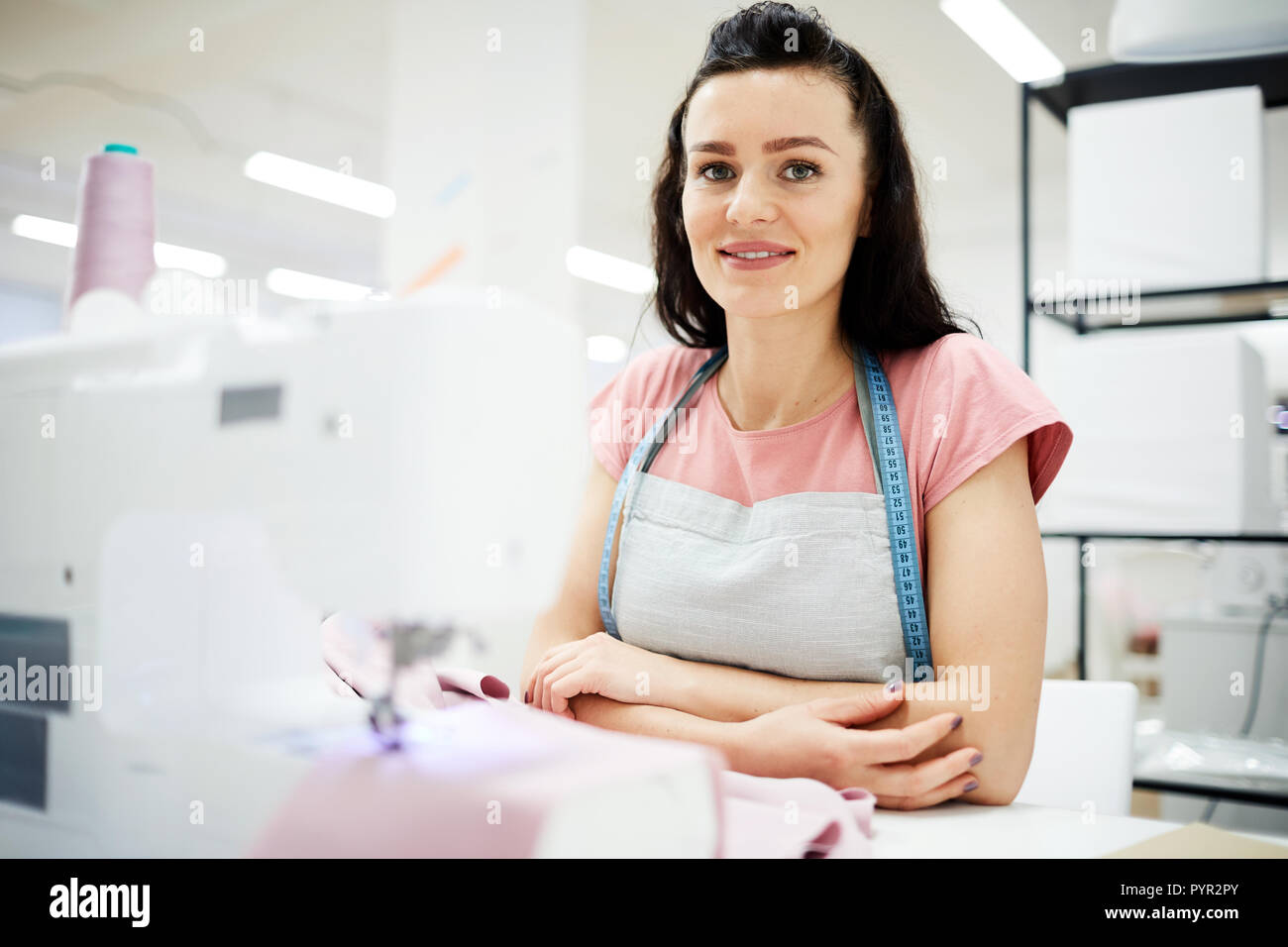 Happy female tailor at workplace Stock Photo