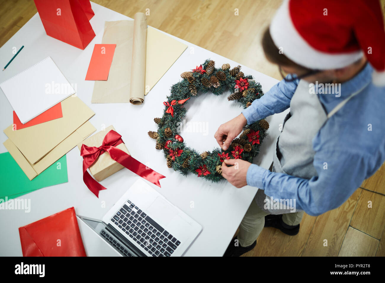 Busy man working on Christmas decoration Stock Photo