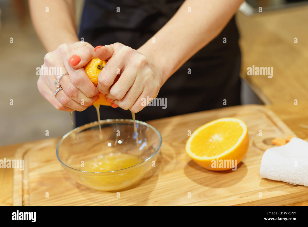 close-up scene of squeezing oranges on kitchen selective focus Stock Photo