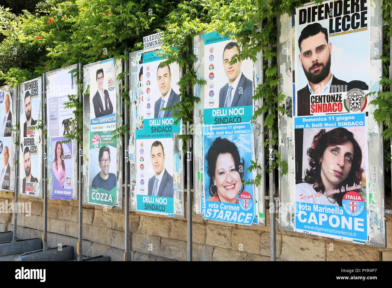 LECCE, ITALY - JUNE 1, 2017: Political candidates posters in Lecce, Italy. Lecce had its municipal elections in June 2017. Stock Photo