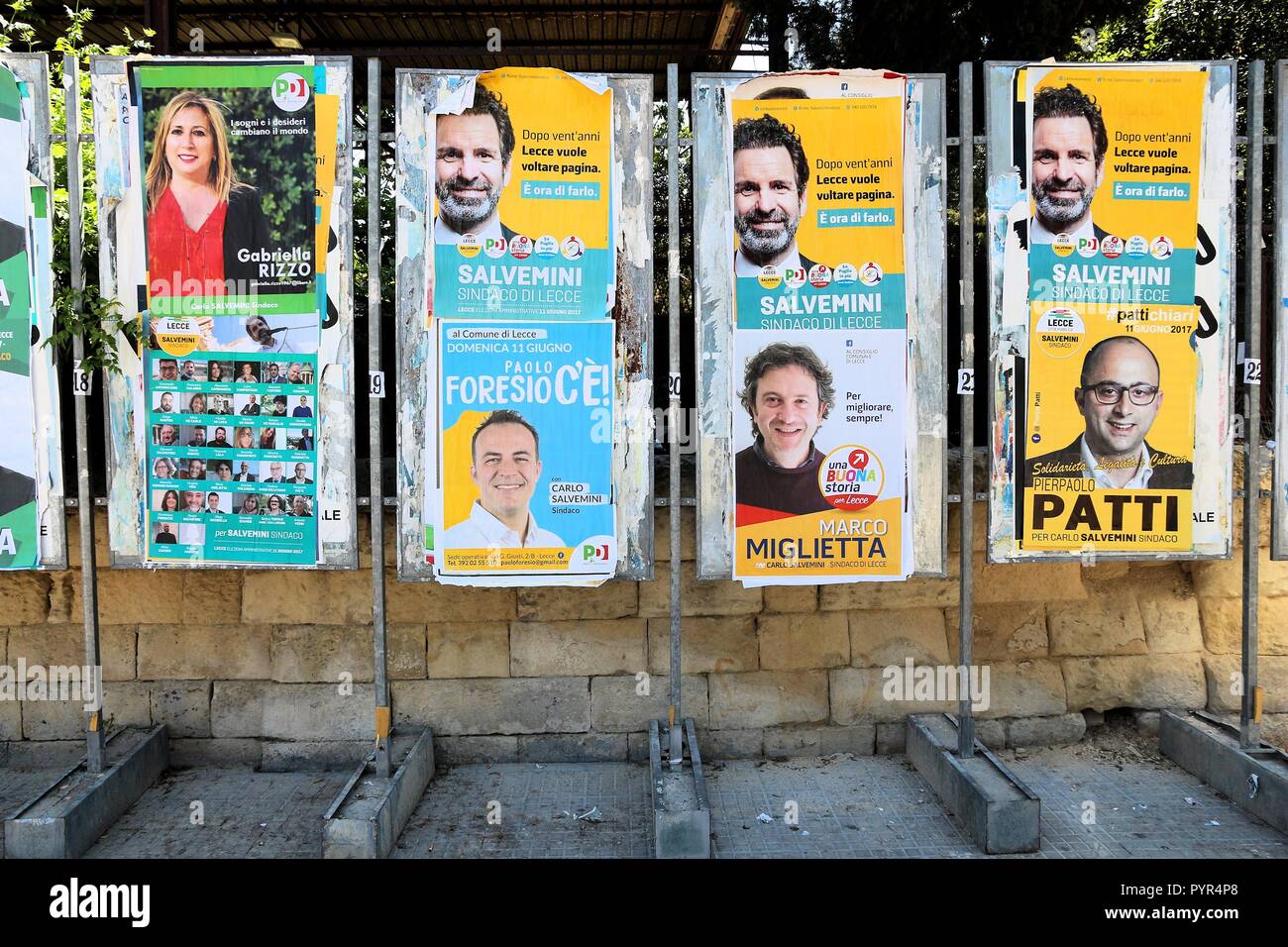 LECCE, ITALY - JUNE 1, 2017: Political candidates posters in Lecce, Italy. Lecce had its municipal elections in June 2017. Stock Photo