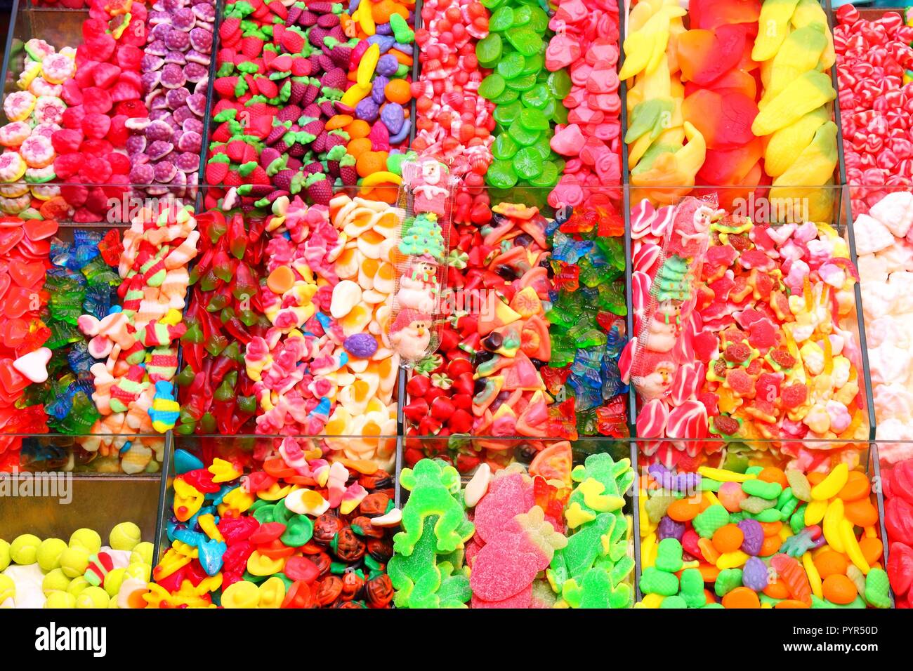 Confectionery shop at Boqueria market in Barcelona, Spain. Colorful gumdrops and wine gum sweets. Stock Photo