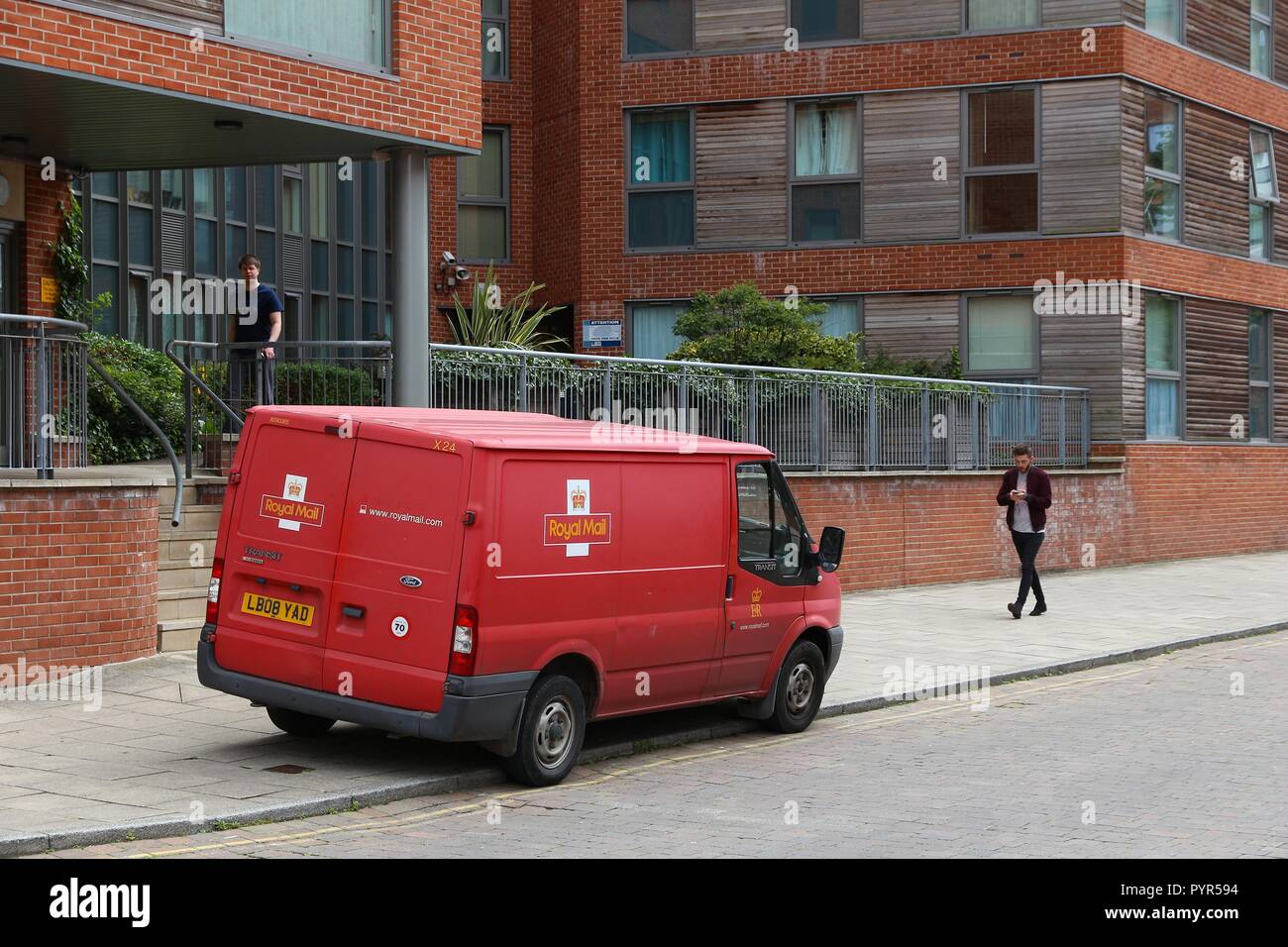 LEEDS, UK JULY 12, 2016 People walk by Royal Mail van in Leeds, UK. Royal Mail was founded in