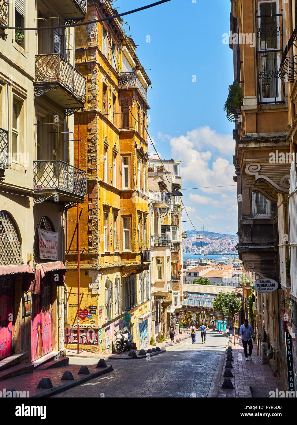 Typical buildings of the Luleci Hendek street, Karakoy district, with the mouth of the Bosphorus in the background. Istanbul, Turkey. Stock Photo
