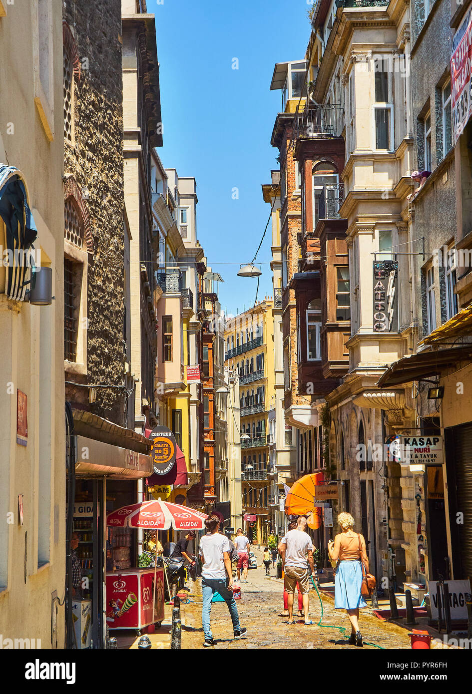 Typical buildings of the Serdar-ı Ekrem street, Karakoy district, with citizens walking. Istanbul, Turkey. Stock Photo