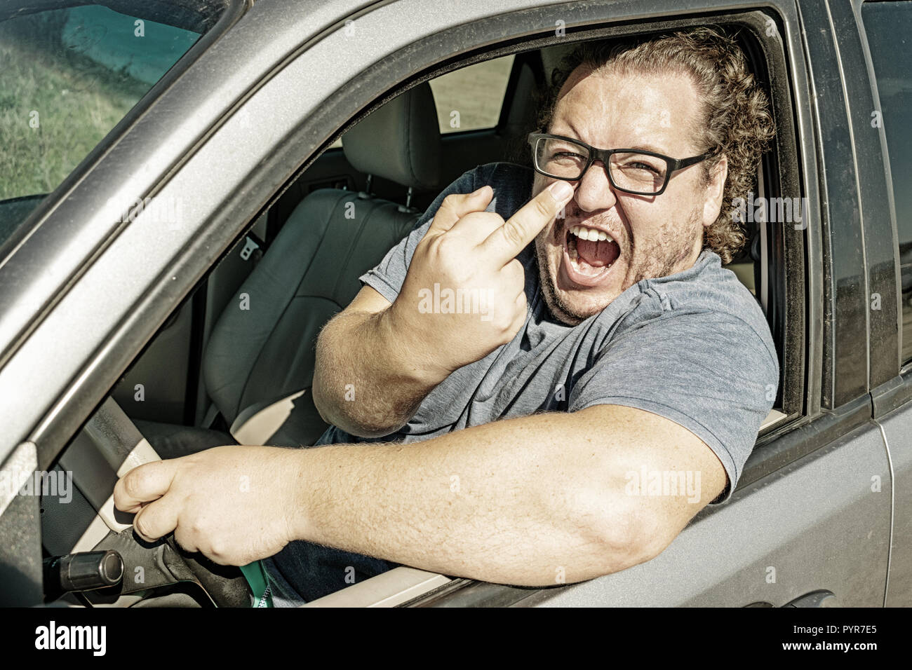 Angry fat man in the car. Road and stress. Traffic incident Stock Photo