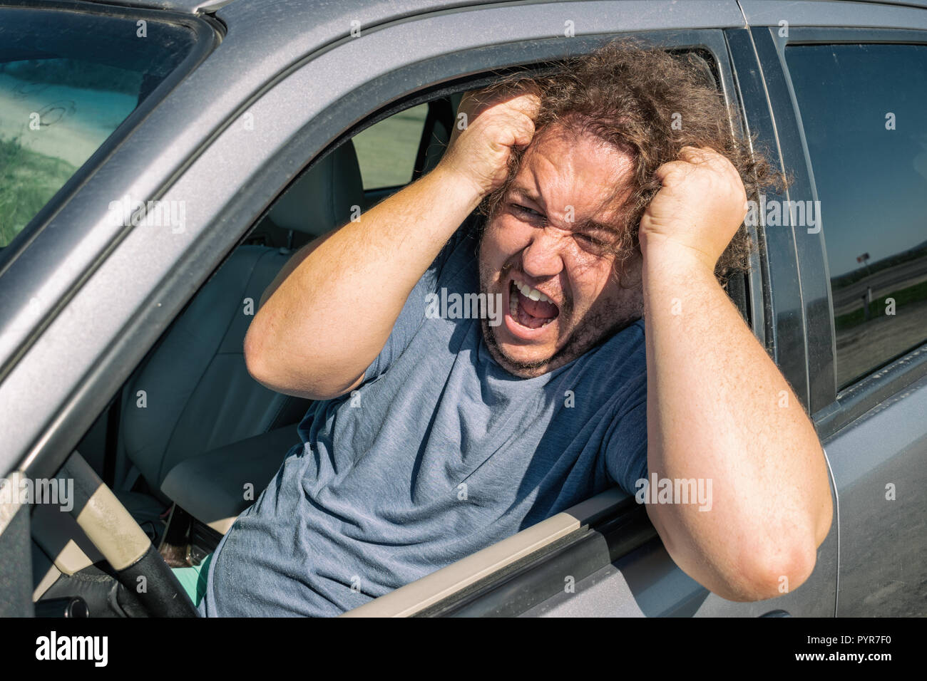 Angry fat man in the car. Road and stress. Traffic incident Stock Photo