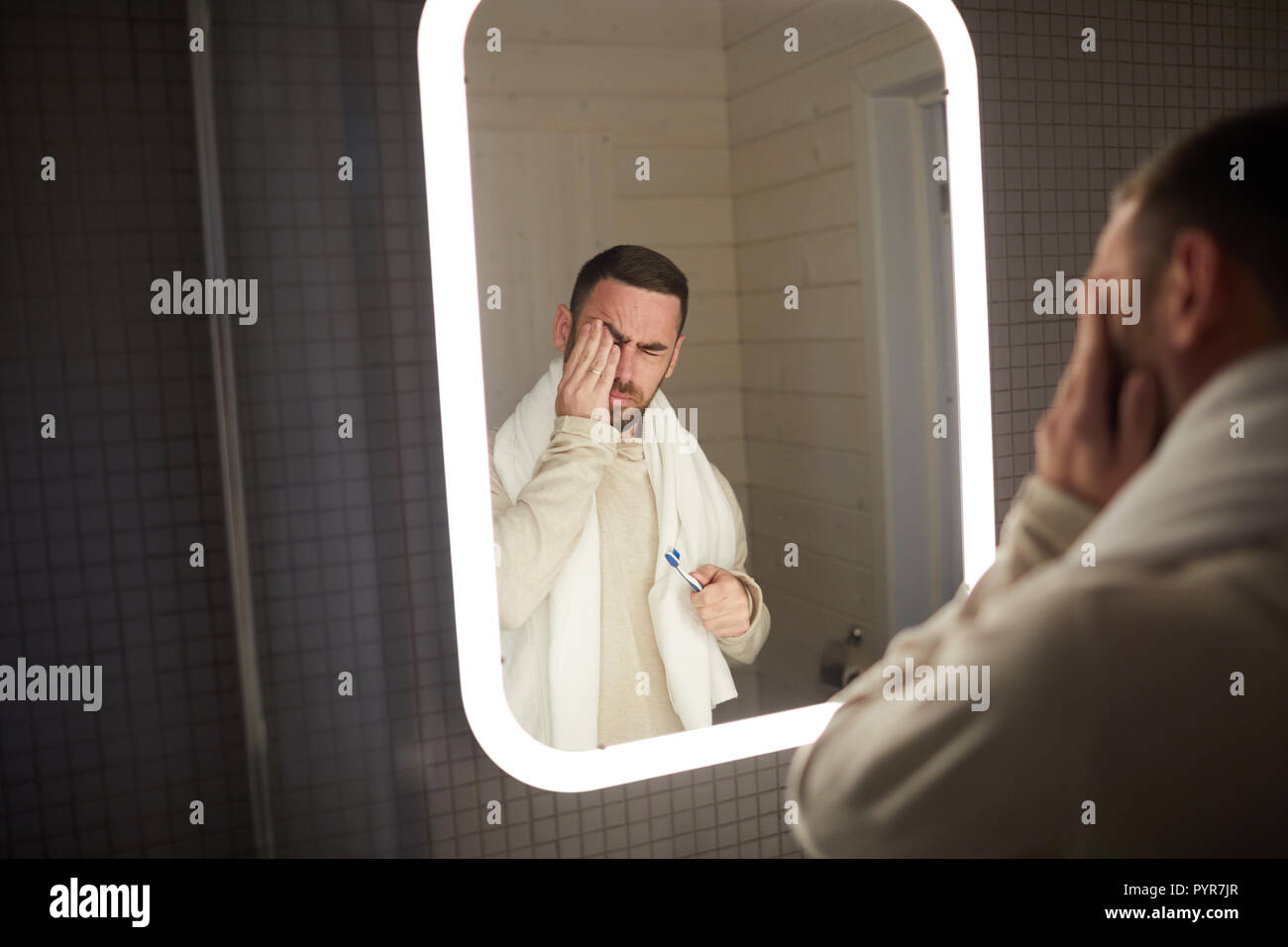 Sleepy Man In Bathroom Stock Photo