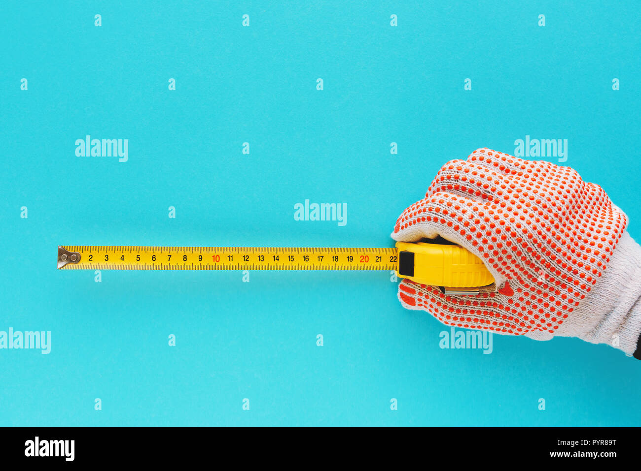 Handyman measuring size with tape meter, hand with tool isolated on